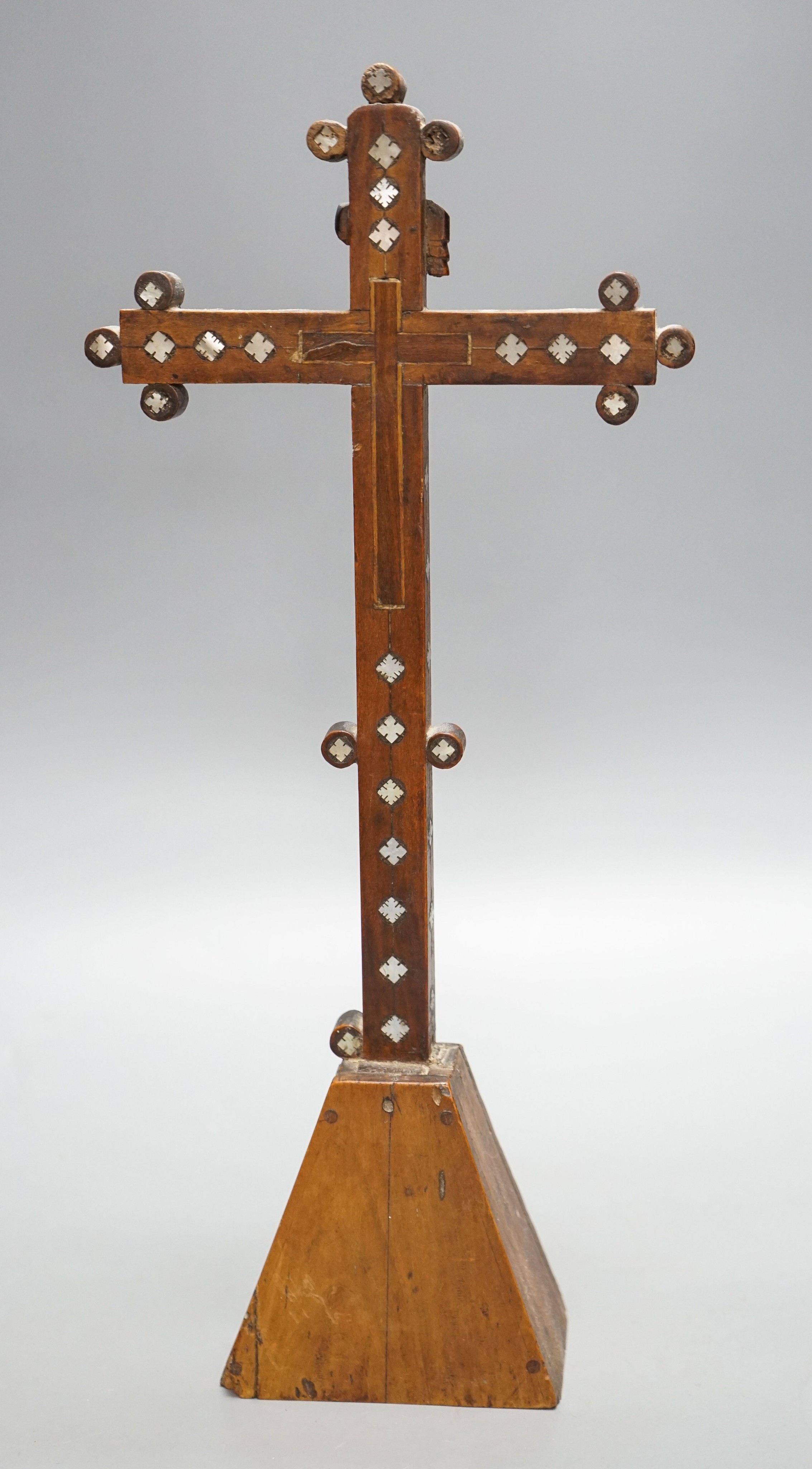 A 19th century Continental fruitwood crucifix with mother of pearl inlay, H 36cm